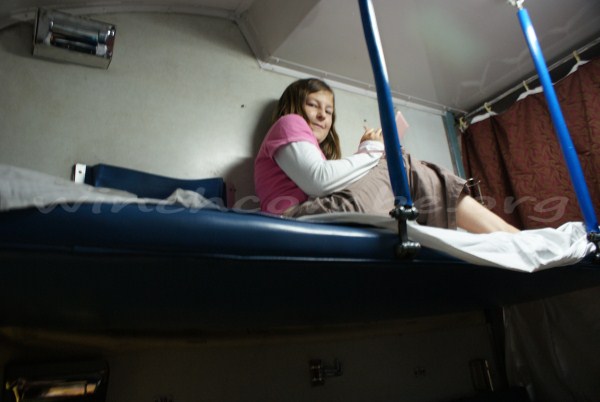 Amy's favourite position on the train, up on the bunk with her DS